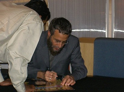 Yusuf Islam signing an autograph